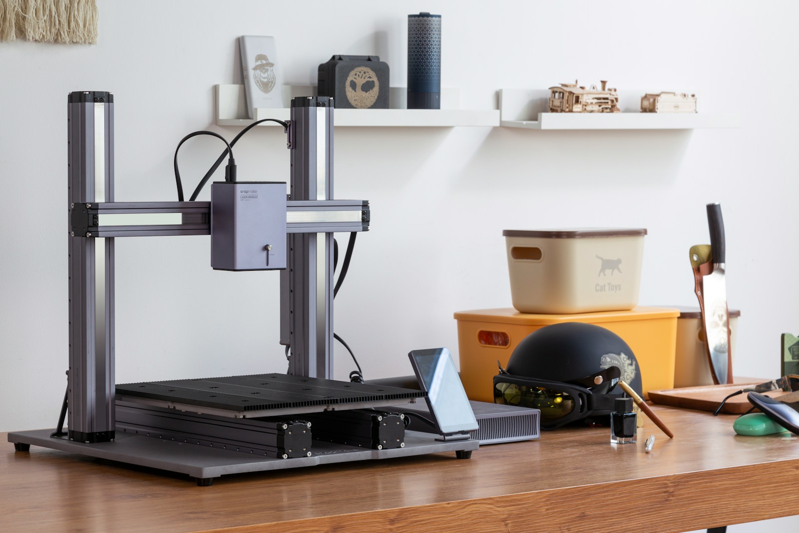 A laptop computer sitting on top of a wooden desk